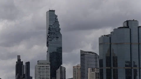 Black clouds are moving past Sathorn Tower Stock Footage 314244235