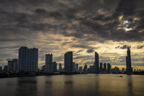 Black clouds are moving through the city at dawn. Stock Photos