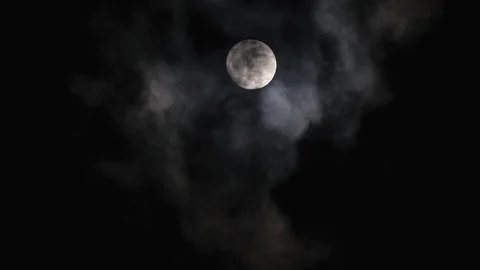 Black clouds passing in front of the moon in the night sky. Outdoor at nightt Stock Footage 95659274