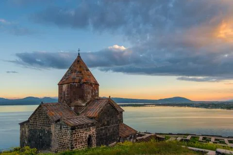 Black clouds at sunset, dramatic sky, view of Sevanavank Monastery and Lake S Stock Photos