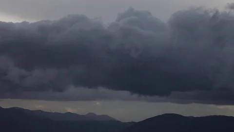 Black clouds, wind, fast storm clouds on hills Video stock 73173369