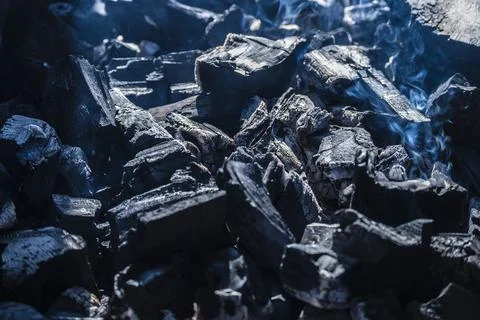 Black coals in the grill close-up, ashes. Stock Photos