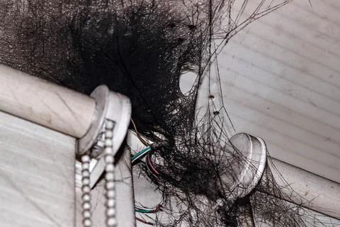 Black cobwebs in soot on the ceiling in the corner. Stock Photos