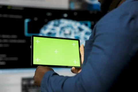 Black coder works on a script with green screen on laptop Stock Photos