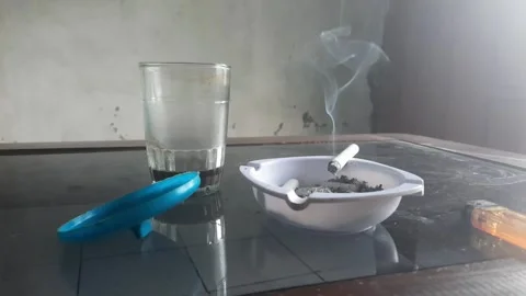 Black coffee and a cigarette on the table Stock Footage 313026388
