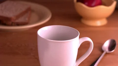 Black coffee being poured into the cup in slow motion Stock Footage 81230558