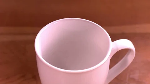 Black coffee being poured into the cup in slow motion Stock Footage 81230591