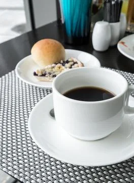 Black coffee with bread on table Stock Photos