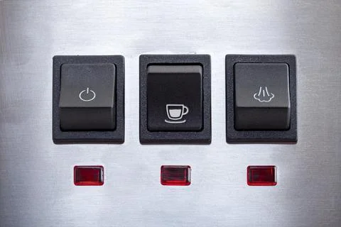 Black coffee brew button with drink cup symbol, close-up of panel. Stock Photos