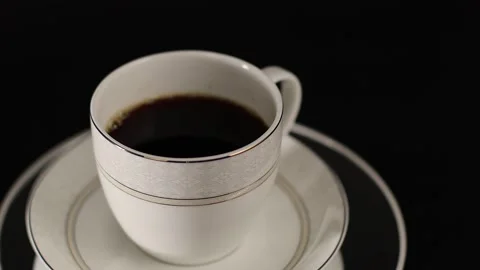 Black coffee cup placed on a rotating stand Stock Footage 250074686