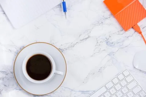 Black coffee on the desk with a computer, mouse Keyboard, book note, and pen  Stock Photos