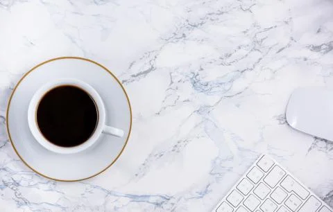 Black coffee on the desk with a computer, mouse Keyboard, book note, and pen  Stock Photos