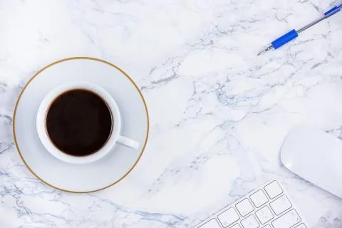 Black coffee on the desk with a computer, mouse Keyboard, book note, and pen  Stock Photos