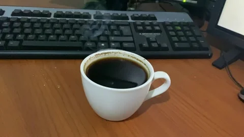 Black coffee drink with smoke on the work desk Video stock 286394752