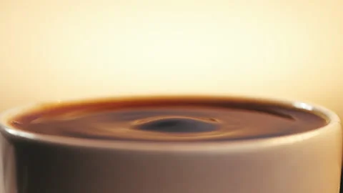 Black coffee drop into the filled Cup from the coffee machine in slow motion Stock Footage 139857435