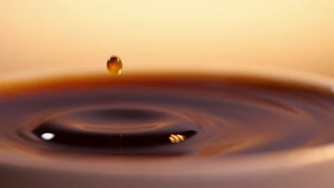 Black coffee drop into the filled Cup from the coffee machine in slow motion Stock Footage 140949177