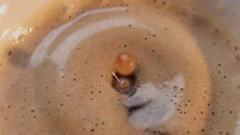 Black coffee drop into the filled Cup from the coffee machine in slow motion Stock Footage 199473851
