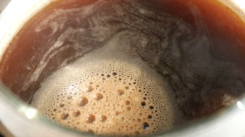 Black coffee foam surface slowly rotates 動画素材 115367411