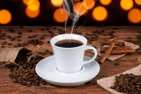Black coffee foil packaging bag on wooden table top view. Spilled beans fla.. Stock Photos