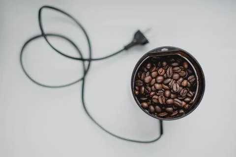 Black coffee grinder with beans Stock Photos