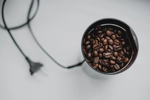 Black coffee grinder with beans Stock Photos