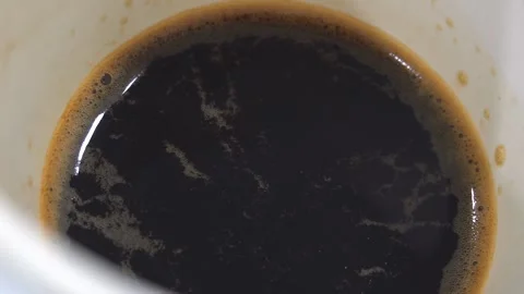 Black coffee liquid inside white paper cup close up view. Food and drink concept Stock Footage 251696841