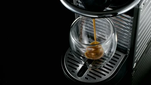 Black coffee machine pouring coffee into the glass cup Stock Footage 133036182
