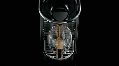 Black coffee machine pouring coffee into the glass cup Stock Footage 133036665