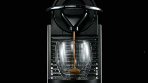 Black coffee machine pouring hot drink into the glass cup Stock Footage 133034765