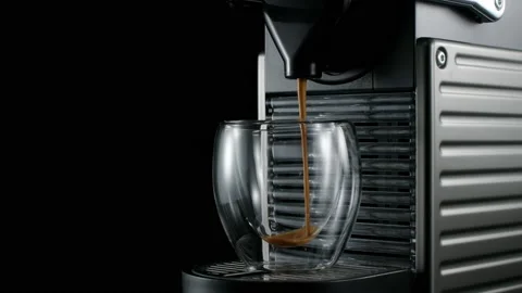Black coffee machine pouring hot drink into the glass cup Stock Footage 133035617
