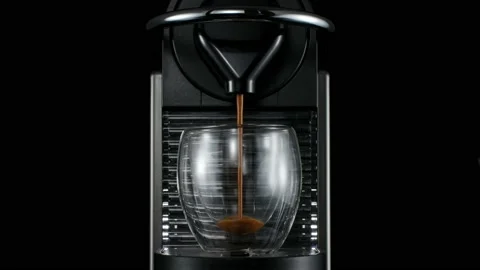 Black coffee machine pouring hot drink into the glass cup Stock Footage 133048171