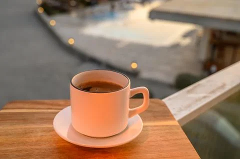 Black coffee in a mug on the background of the pool Stock Photos