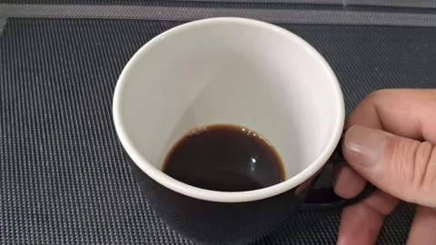 Black coffee mug held in hand motion video footage clip Video stock 339249054