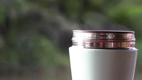 Black coffee is poured into a blue cup with rising steam above. Stock Footage 227346159
