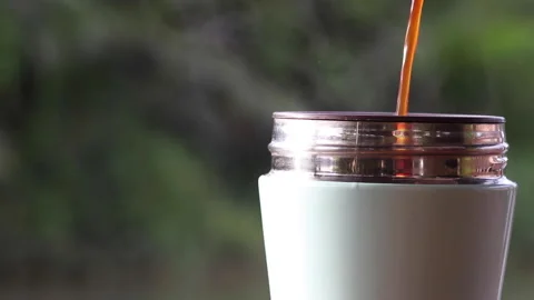 Black coffee is poured into a blue cup with rising steam above. Stock Footage 227346219