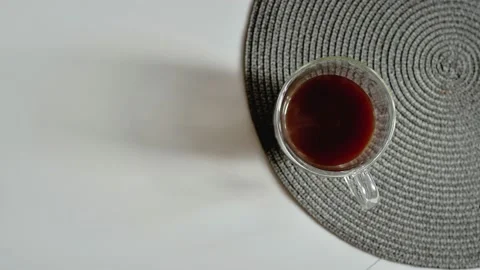 Black coffee pouring from coffee maker jug into the white cup on wooden table Video stock 172313176
