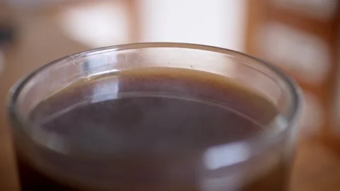 Black Coffee Stays Still in a Clear Glass Cup Under Soft Indoor Lighting Stock-Footage 339067241