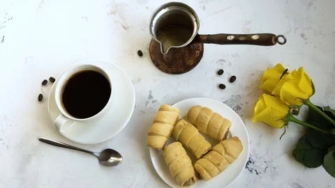 Black coffee in a white cup and yellow roses on the table. Stock Footage 85159692