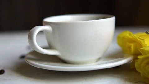 Black coffee in a white cup and yellow roses on the table. Stock Footage 85544006