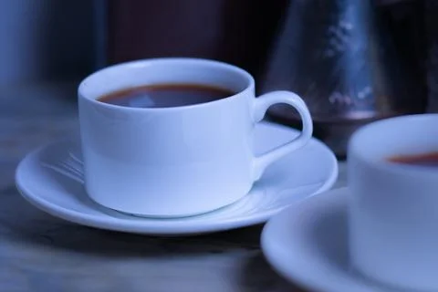 Black coffee in a white cup on the table Stock Photos