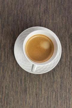 Black coffee in a white mug on the table. Flat lay. Stock Photos