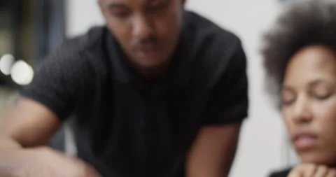 Black colleagues discussing data on tablet Stock Footage 195218203