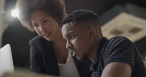 Black colleagues using laptop together Stock Footage 195221043