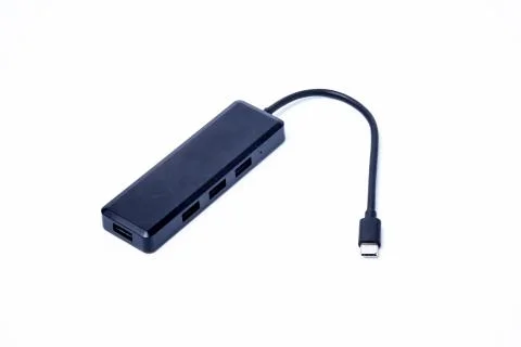 The black color of the multi USB type-c hub converter to the laptop. Isolated Stock Photos