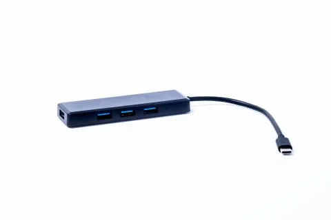 The black color of the multi USB type-c hub converter to the laptop. Isolated Stock Photos