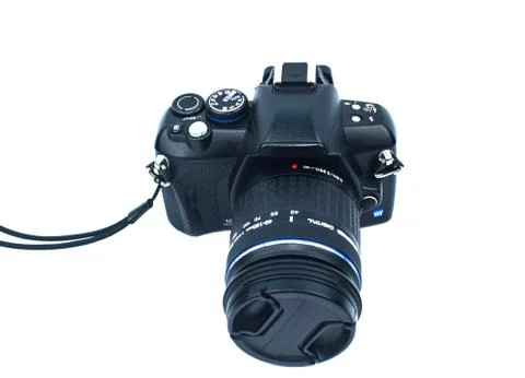 Black colored digital camera with a nice lens attached to it on top of white Stock Photos