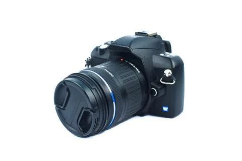 A black colored digital camera with a nice lens attached to it on top of whit Stock Photos