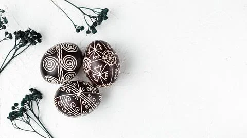 Black colored Easter eggs. Pysanka on white Stock Photos