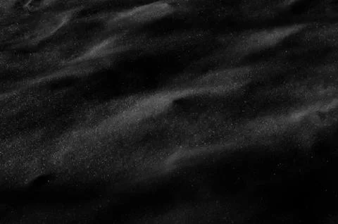 Black colored textured snow surface as background Stock Photos