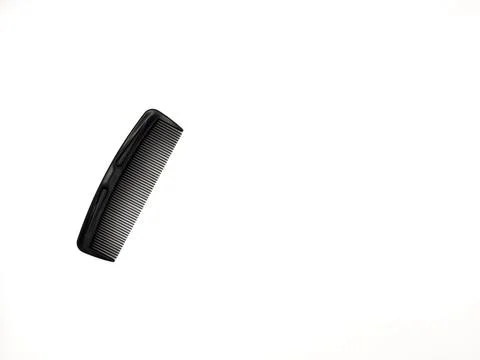 A black comb with a black handle. The comb is laying on a white background, copy Stock Photos